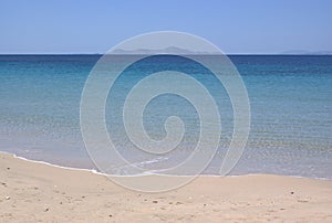 Greece, the island of Donoussa, the placid waters of the town beach.