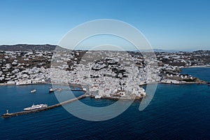 Greece, Mikonos island, Cyclades. Aerial drone view. Mikonos Chora whitewashed buildings cityscape, port and coastline