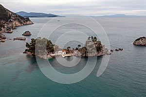 Greece Parga. Aerial drone view of Panagia island, small chapel and trees on the rock