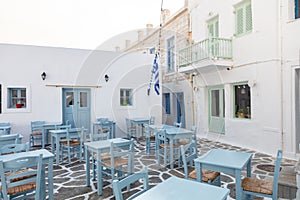 Outdoor cafe empty tables at Naousa old harbor. Greece, Paros island, Cyclades. Summer vacation