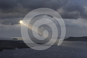 Greece. Piercing sunbeam over Santorini island