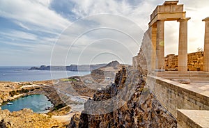 Greece. Rhodes. Acropolis of Lindos. Doric columns of ancient Temple of Athena Lindia the IV century BC and the bay of