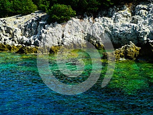 Greece rocky coasline, green, blue, turqouise, aquamarine water, mediterranean sea. photo
