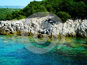 Greece rocky coasline, green, blue, turqouise, aquamarine water, mediterranean sea. photo