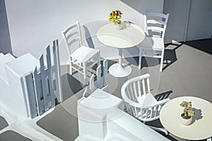 Greece, Santorini island, Oia. Conceptual white architecture, top view. Tables and chairs. Abstract background. Greek Islands,