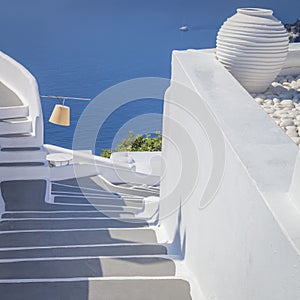 Greece, Santorini island, Oia - white architecture of a narrow street, steps lead to the sea. Greek Islands, Santorini