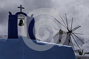 Greece, Santorini, Oia, view of the village with windmill, cross and bell