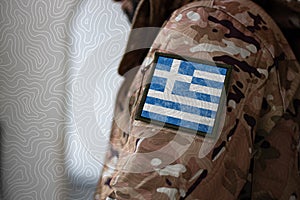 Greece Soldier, Soldier with flag Greece, Greece flag on a military uniform. Camouflage clothing