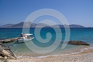 Greece, A solitary fishing boat. The island of Keros in the background.