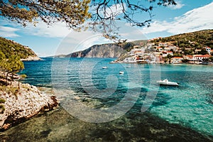 Greece summer vacation. Beautiful Assos small town located on Kefalonia island. Bay with boats and village in background photo