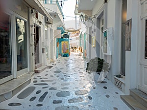 Greece Tinos island, Chora town. Cyclades, souvenir shop, outdoors cafe, paved alley