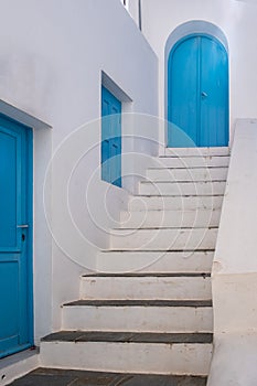 Greece. Traditional architecture in white and blue. Greek island building and stair, door and window