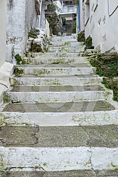 Greece, Tzia Kea island. Ioulis city narrow street with stairs and traditional stone walls
