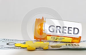 Greed on a pill bottle with yellow pills on money