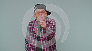 Greedy avaricious senior grandfather man showing fig negative gesture, refusal fig sign, rapacious