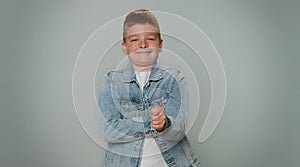 Greedy avaricious aggressive toddler boy child showing fig negative gesture, rapacious, avaricious photo