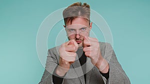 Greedy avaricious young business man showing fig refusal negative disapproval dislike disgust sign photo