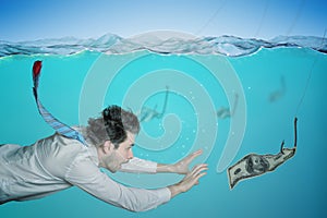 Greedy businessman is swimming in water and catching money on bait. Fraud concept
