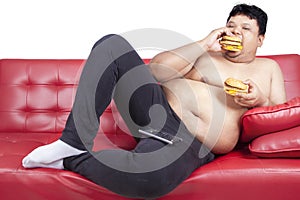 Greedy fat man eating hamburger 1