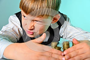 A greedy and greedy rich boy with money looks around, hiding coins from thieves and enemies