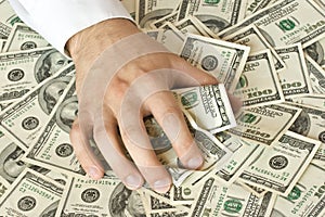 Greedy hand grabs money photo