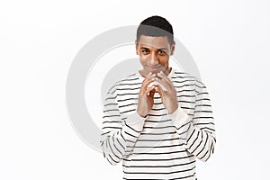 Greedy man scheming, making sly, devious plan, standing over white background