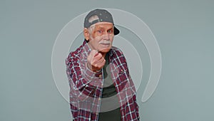 Greedy avaricious senior grandfather man showing fig negative gesture, refusal fig sign, rapacious photo