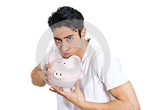 greedy stingy man holding piggy bank isolated on white background