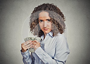 Greedy woman corporate business employee holding dollar banknotes tightly