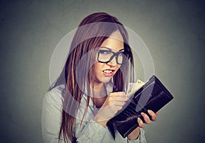 Greedy woman counting taking out money from her wallet