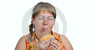 Greedy woman eating burger.