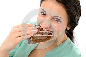 Greedy young woman eating tasty cake photo