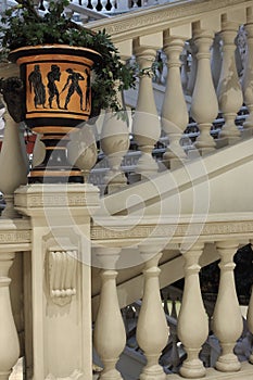 Greek ancient architecture. Stone and marble stairs with greek vase with plant. Old architecture design.