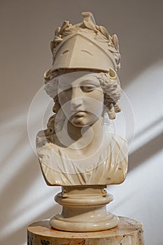 Greek ancient statue of goddess Athena. Woman marble head in helmet sculpture photo