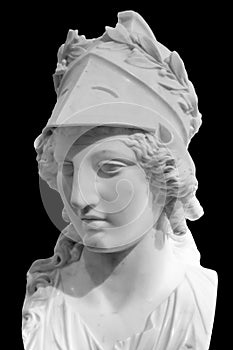 Greek ancient statue of goddess Athena. Woman marble head in helmet sculpture isolated on black