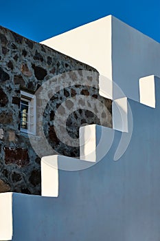 Greek architecture abstract background - whitewashed house with stairs. Milos island, Greece