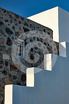 Greek architecture abstract background - whitewashed house with stairs. Milos island, Greece