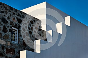 Greek architecture abstract background - whitewashed house with stairs. Milos island, Greece