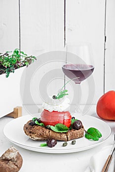 Barley rusk called dakos ,topped with feta cheese, tomato cubes,olive oil and oregano ,typical Greek plate served with