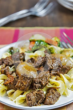 Greek beef stifado with egg noodles and roasted vegetables