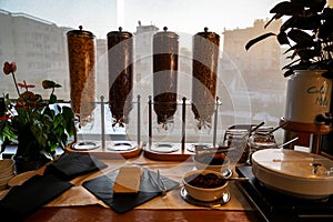 Greek breakfast buffet table full with varieties of cereal in dispensing towers, yoghurt, cold milk, dried fruit, etc.