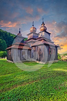 Greek Catholic wooden church of St. Paraskieva in Dobroslava during epic sunrise