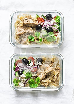 Greek chicken grain lunch box. Lemon herbs chicken, couscous, vegetables, olives, feta cheese lunch box on light background, top