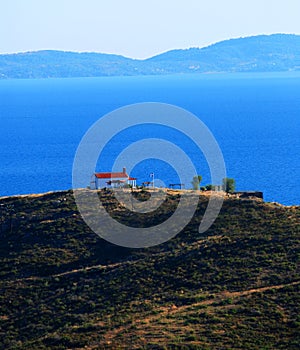 Greek church on hill overlooking sea