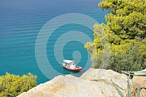 Greek coast, ship under a rock.
