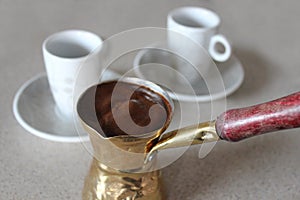 Greek coffee in briki with two cups photo