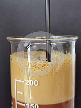 Greek coffee frape in test tube photo