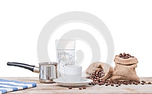 Greek coffee with pot and sacks full of coffee beans.