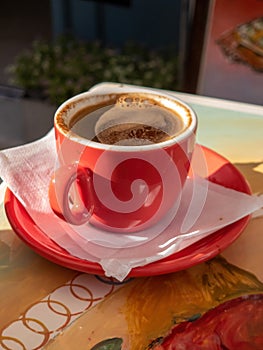 Greek coffee or Turkish served with foam on the top, Cyclades island, Greece. Vertical