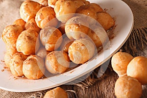 Greek dessert loukoumades with honey and cinnamon closeup. horizontal